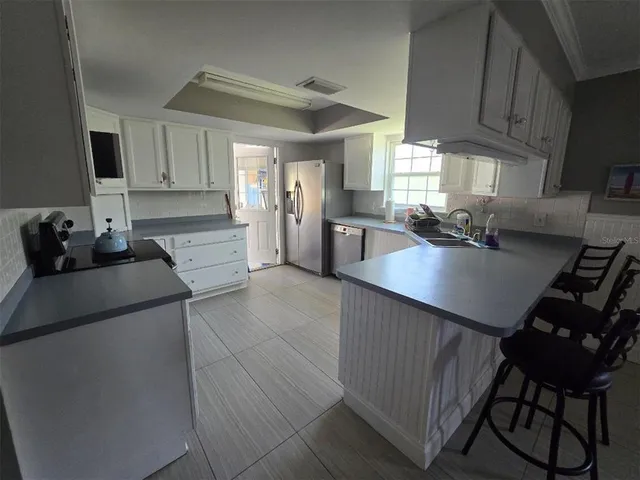 a kitchen with a table chairs stove and cabinets