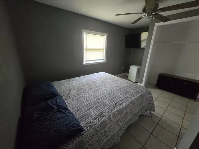 a bedroom with a bed and a window