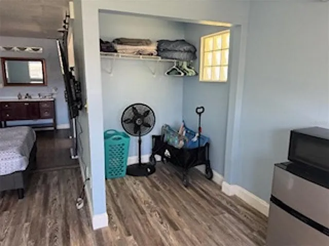 a view of a livingroom with furniture hardwood floor a fireplace and windows