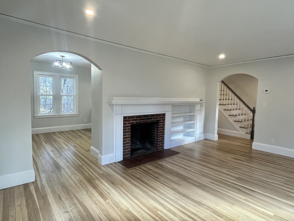 11 Park Lane Walpole, MA 02032 - Photo 13 of 27 an empty room with wooden floor fireplace and windows