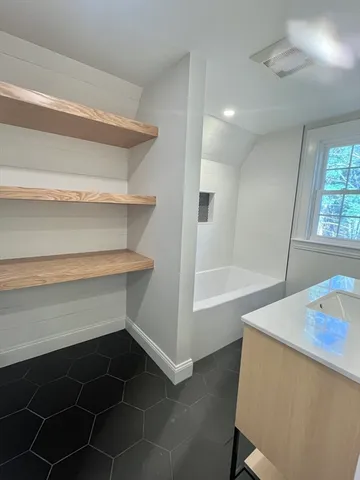 a bathroom with a bathtub and a sink