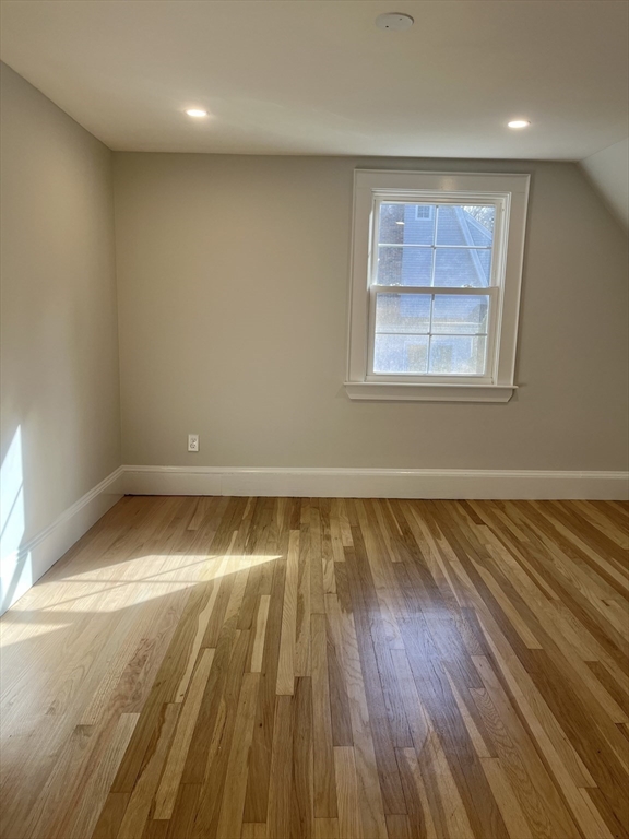 11 Park Lane Walpole, MA 02032 - Photo 25 of 27 an empty room with wooden floor and windows