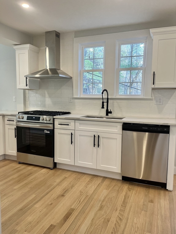 11 Park Lane Walpole, MA 02032 - Photo 6 of 27 a kitchen with white cabinets appliances a sink and a window