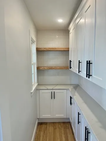 a view of a kitchen with a sink and cabinets