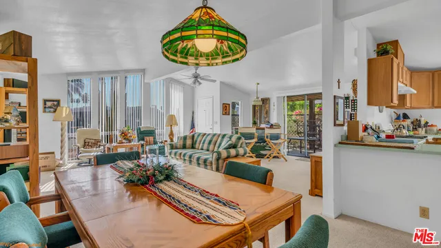 a living room with furniture a rug and a chandelier