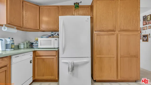 a white refrigerator freezer sitting in a kitchen