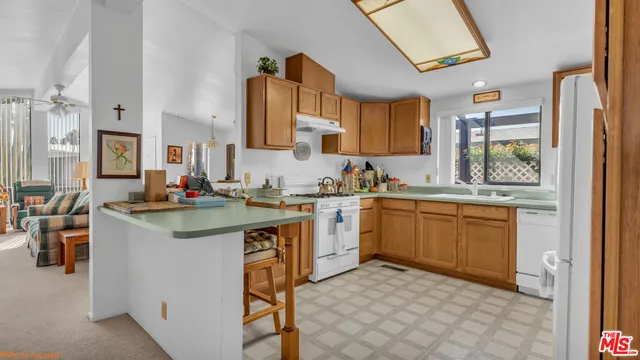 a kitchen with a sink cabinets and window