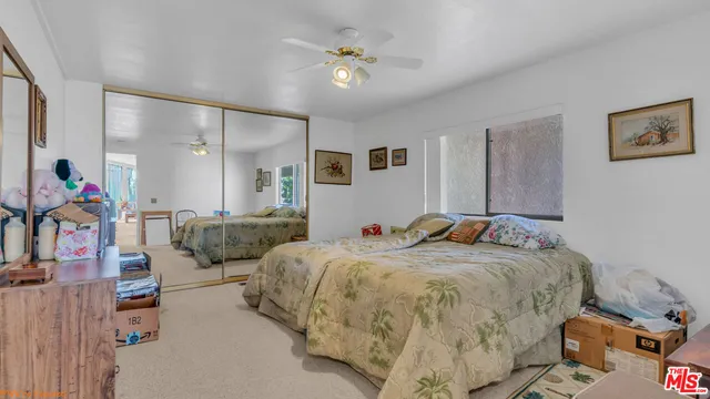a bed room with a bed and a chandelier