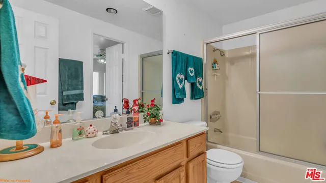 a bathroom with a sink vanity mirror and toilet