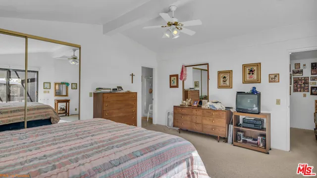 a bedroom with a bed and dresser