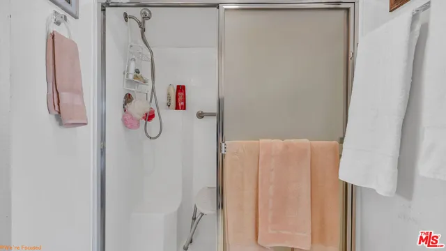 a bathroom with a shower and a shower curtain