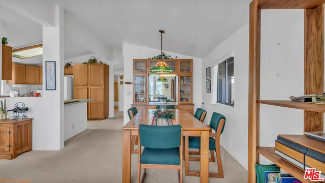 a dining room with furniture a chandelier and wooden floor
