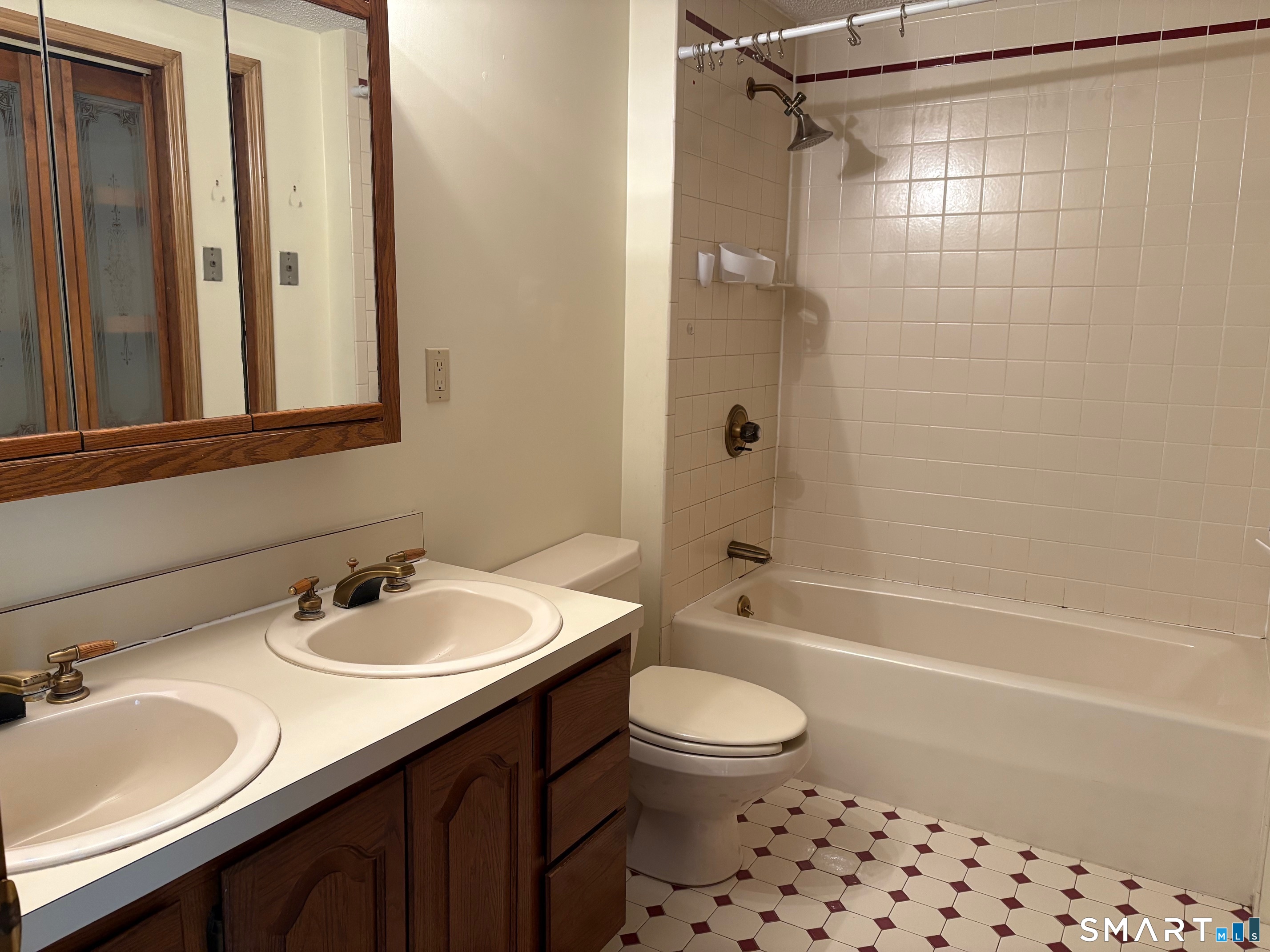 693 Broad Street Meriden, CT 06450 - Photo 12 of 19 This is the full bathroom on the main level that features a vaniity with double sinks.