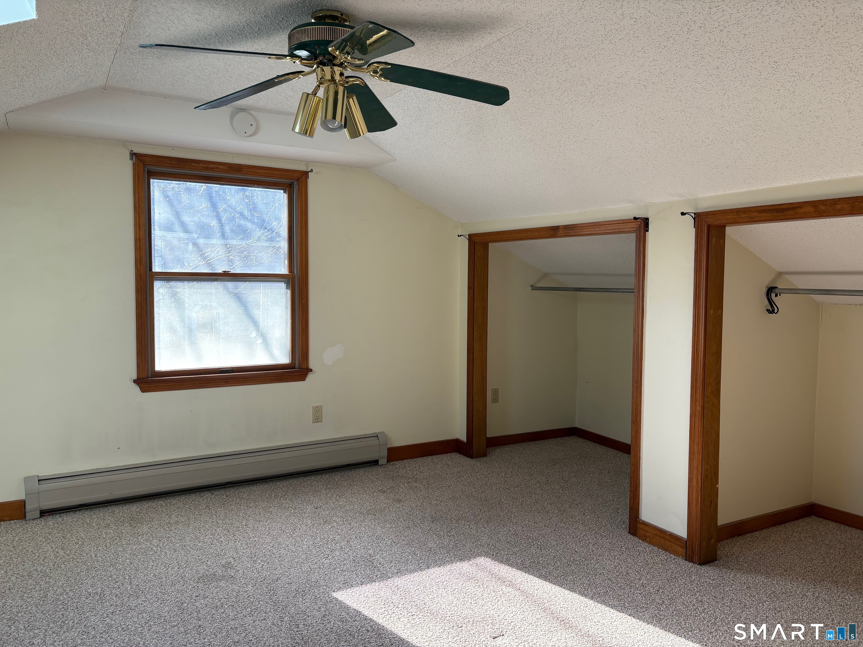 693 Broad Street Meriden, CT 06450 - Photo 13 of 19 The large primary bedroom offers plenty of closet space.