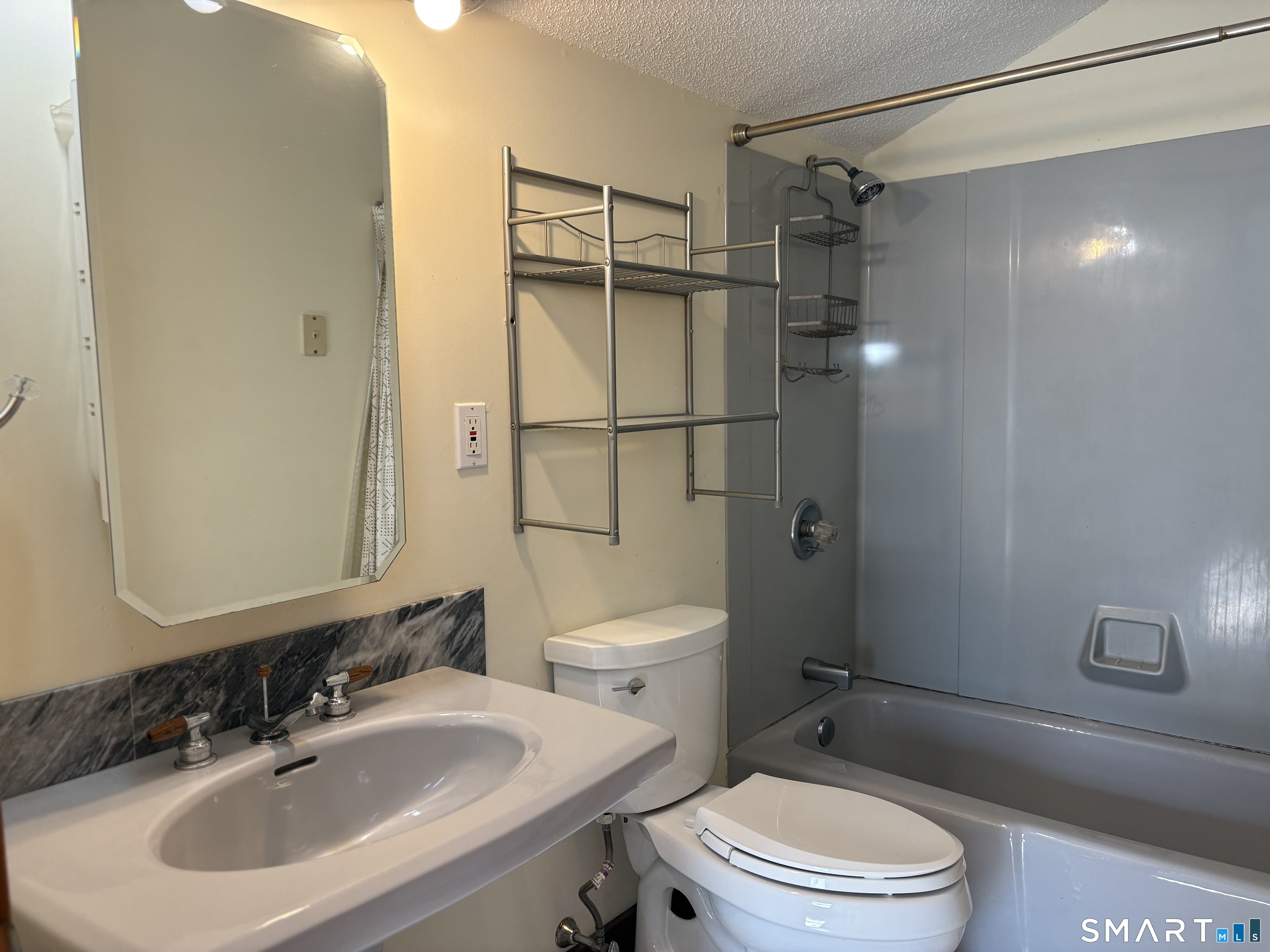 693 Broad Street Meriden, CT 06450 - Photo 16 of 19 This modern full bathroom is off the primary bedroom.