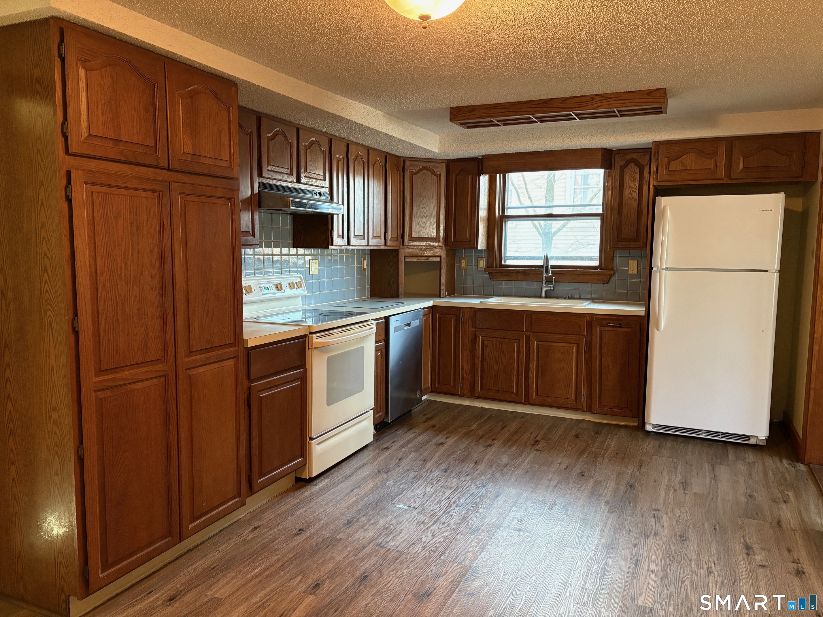 693 Broad Street Meriden, CT 06450 - Photo 4 of 19 Large, fully applianced eat-in kitchen with ample cabinet space for all your litchen storage needs.