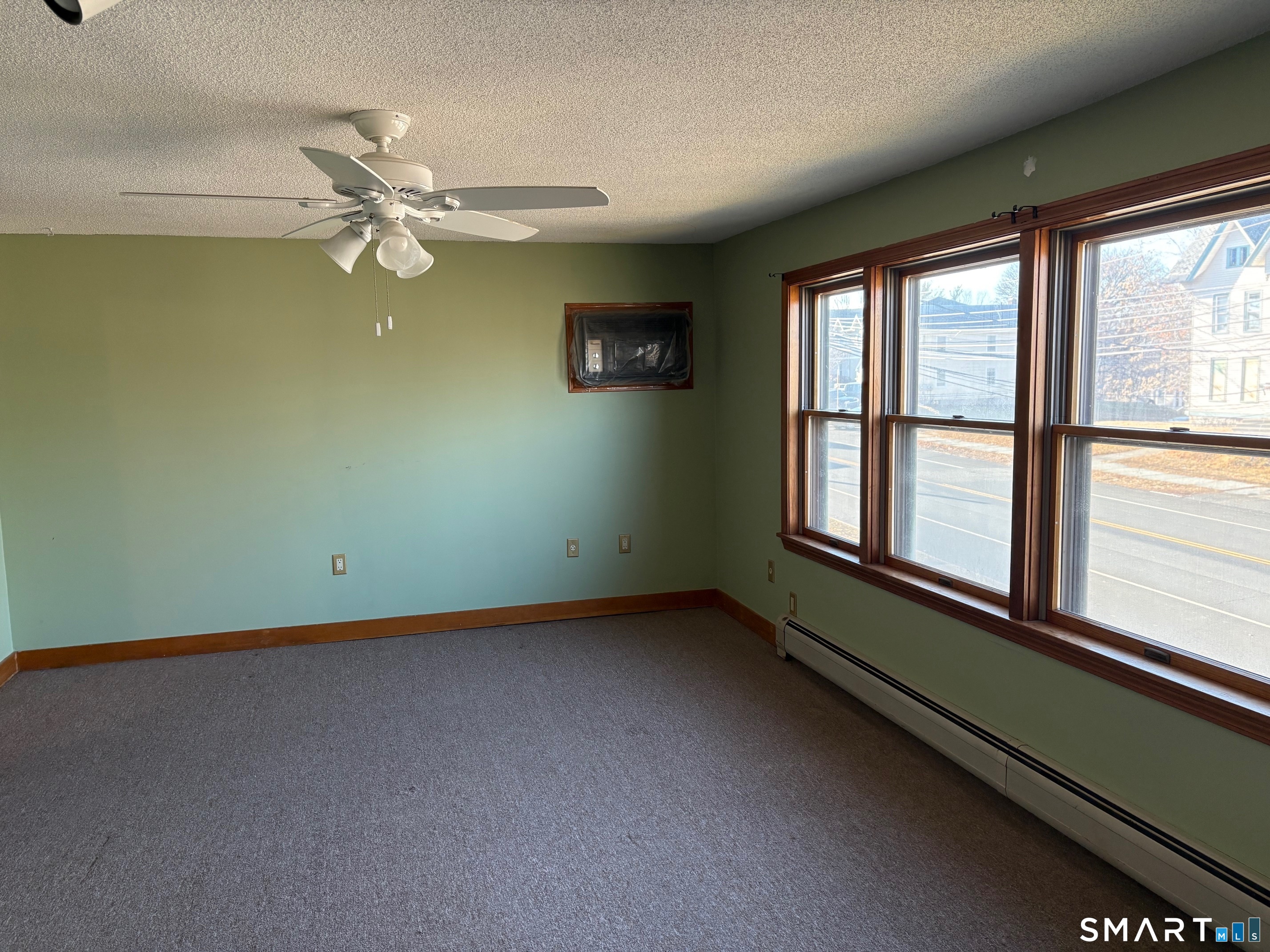 693 Broad Street Meriden, CT 06450 - Photo 7 of 19 A wall of windows in the living room allows plenty of natural light into this room.