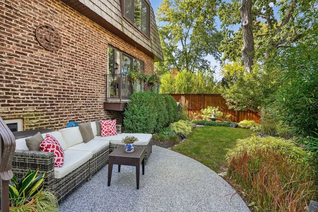 a view of a patio with couches table and chairs and potted plants
