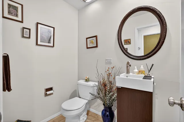 a bathroom with a sink mirror and toilet