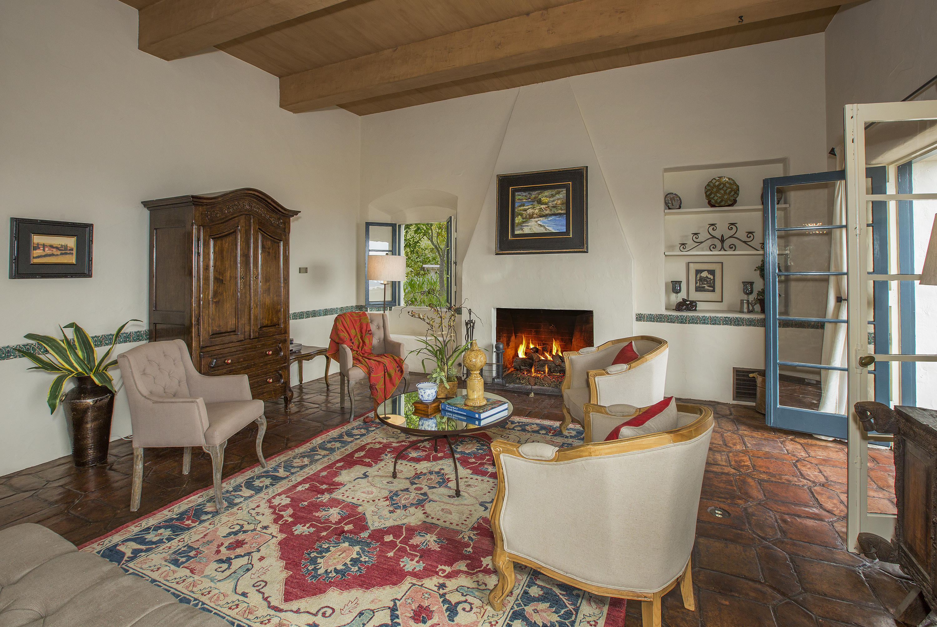 1919 Las Tunas Road Santa Barbara, CA 93103 - Photo 10 of 27 a living room with furniture a rug and a fireplace