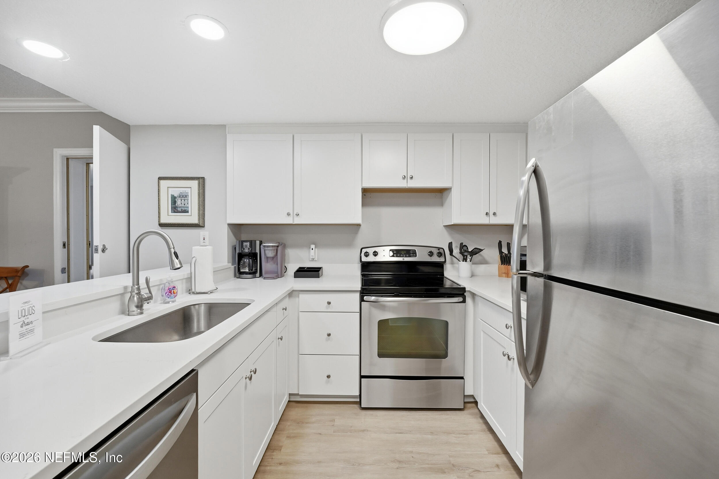 1817 Turtle Dunes Place Fernandina Beach, FL 32034 - Photo 11 of 34 a kitchen with a sink stainless steel appliances and cabinets