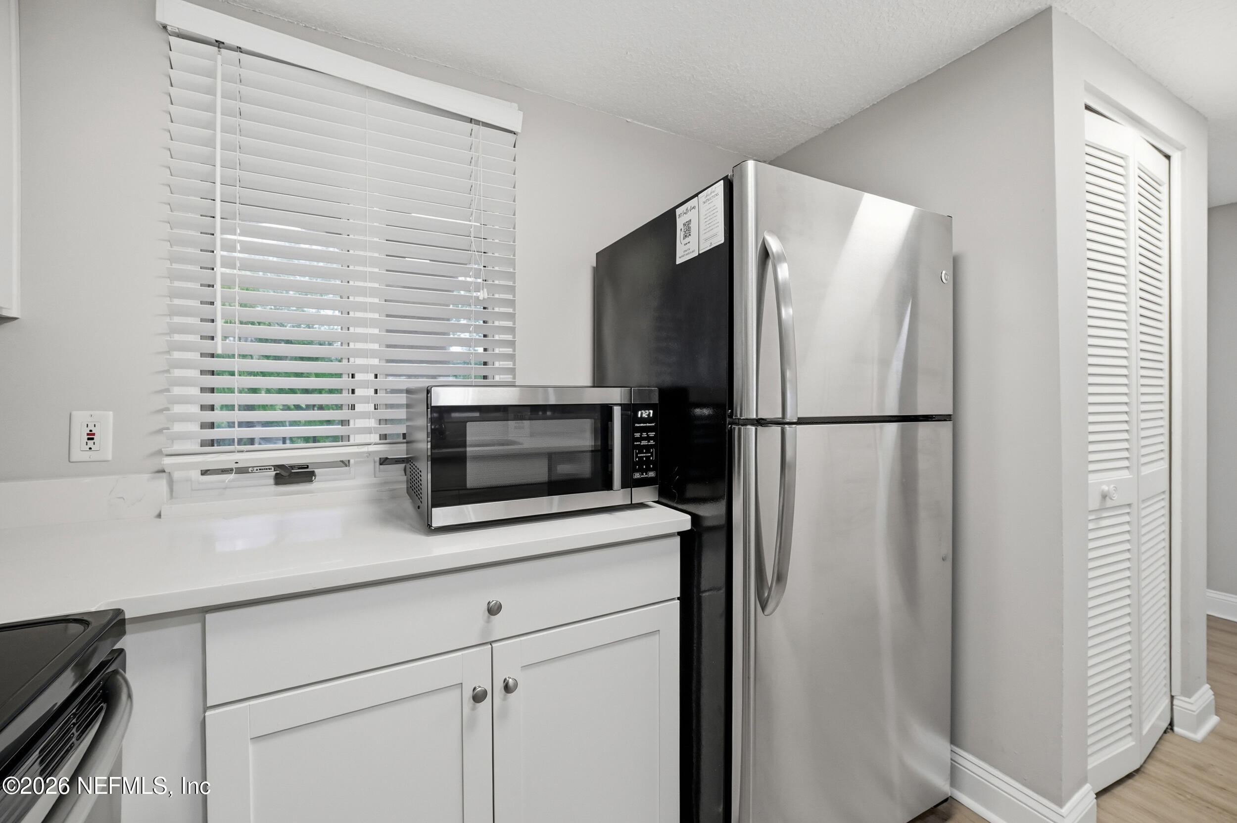 1817 Turtle Dunes Place Fernandina Beach, FL 32034 - Photo 12 of 34 a kitchen with stainless steel appliances granite countertop a refrigerator and a sink