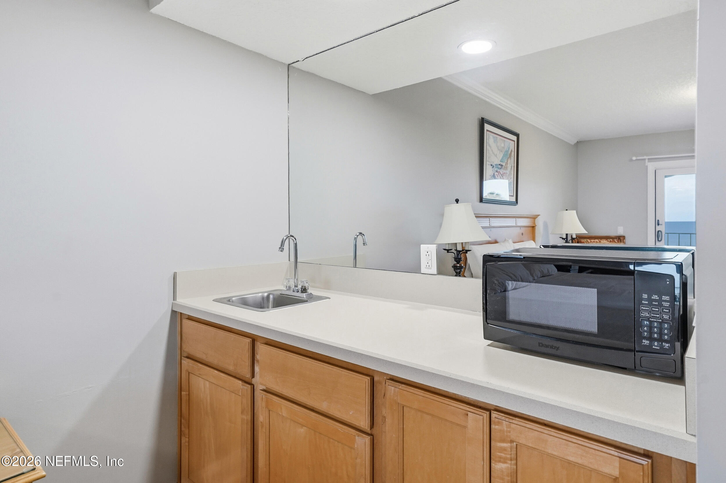 1817 Turtle Dunes Place Fernandina Beach, FL 32034 - Photo 19 of 34 a kitchen with a sink and a microwave