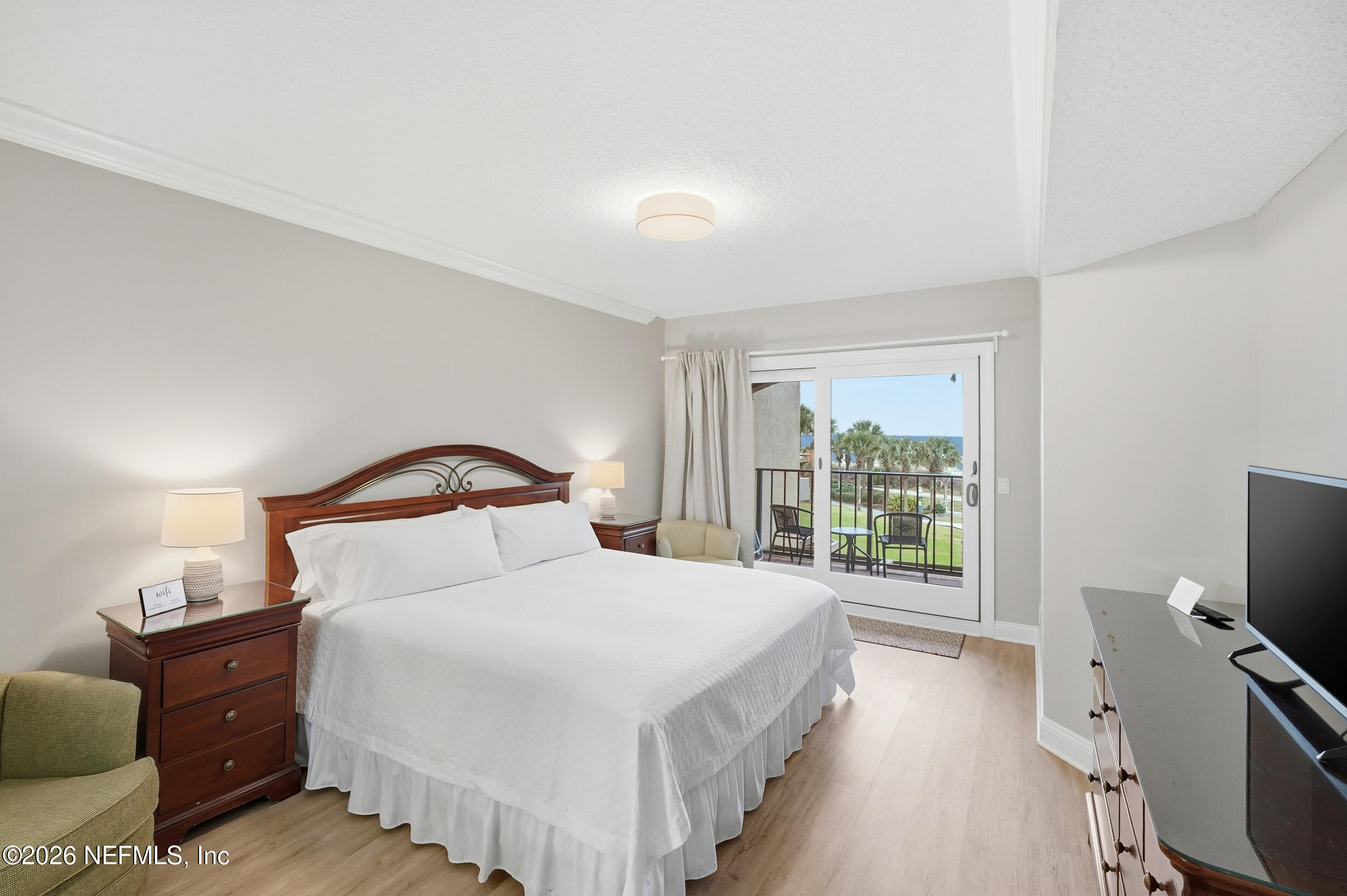 1817 Turtle Dunes Place Fernandina Beach, FL 32034 - Photo 22 of 34 a bedroom with a bed and tv on the dresser