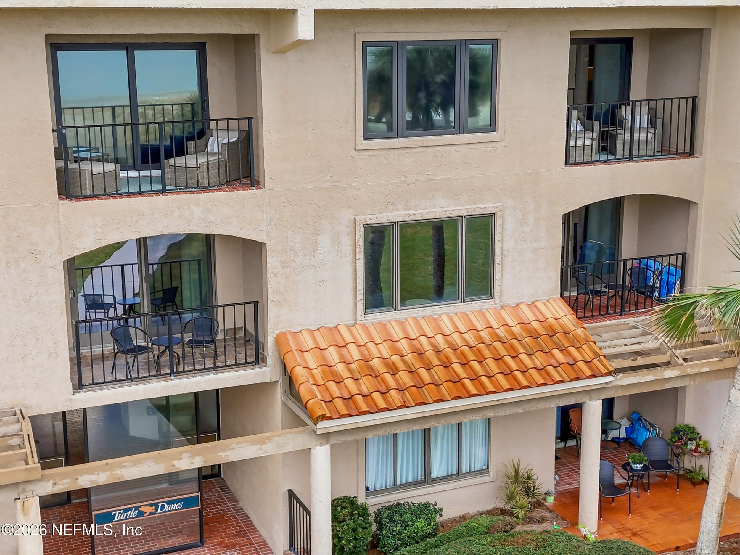 1817 Turtle Dunes Place Fernandina Beach, FL 32034 - Photo 29 of 34 a front view of a house with large windows