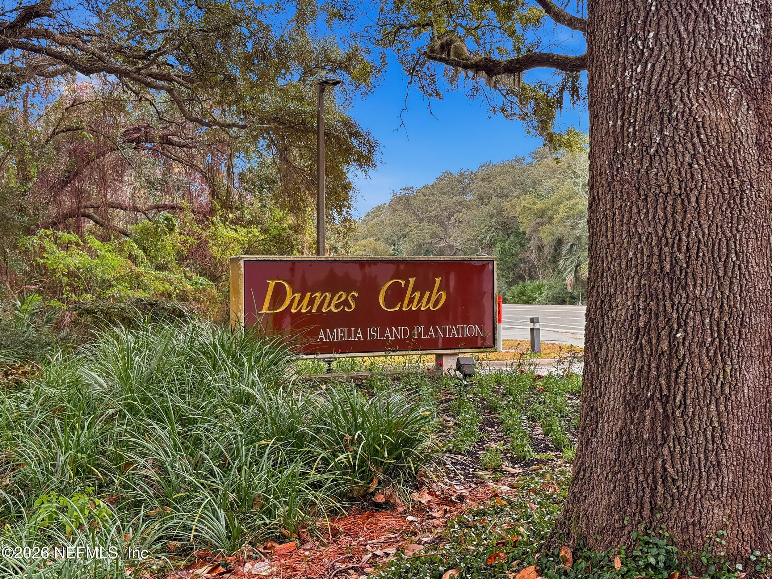 1817 Turtle Dunes Place Fernandina Beach, FL 32034 - Photo 30 of 34 a sign that is sitting on a brick wall
