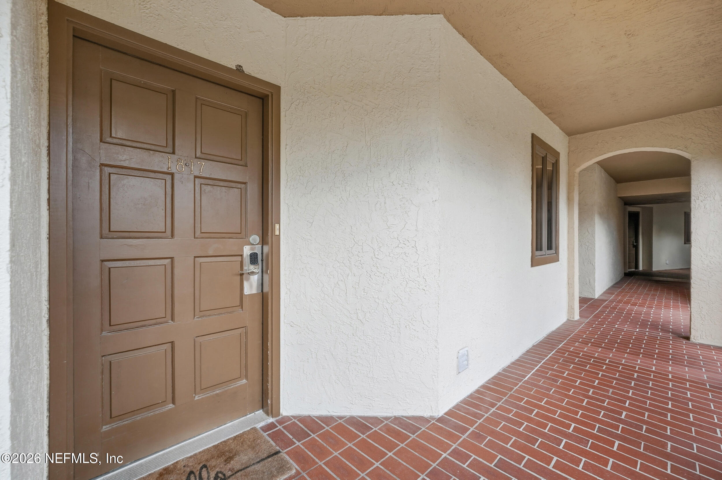 1817 Turtle Dunes Place Fernandina Beach, FL 32034 - Photo 3 of 34 a view of a hallway with wooden floor and closet