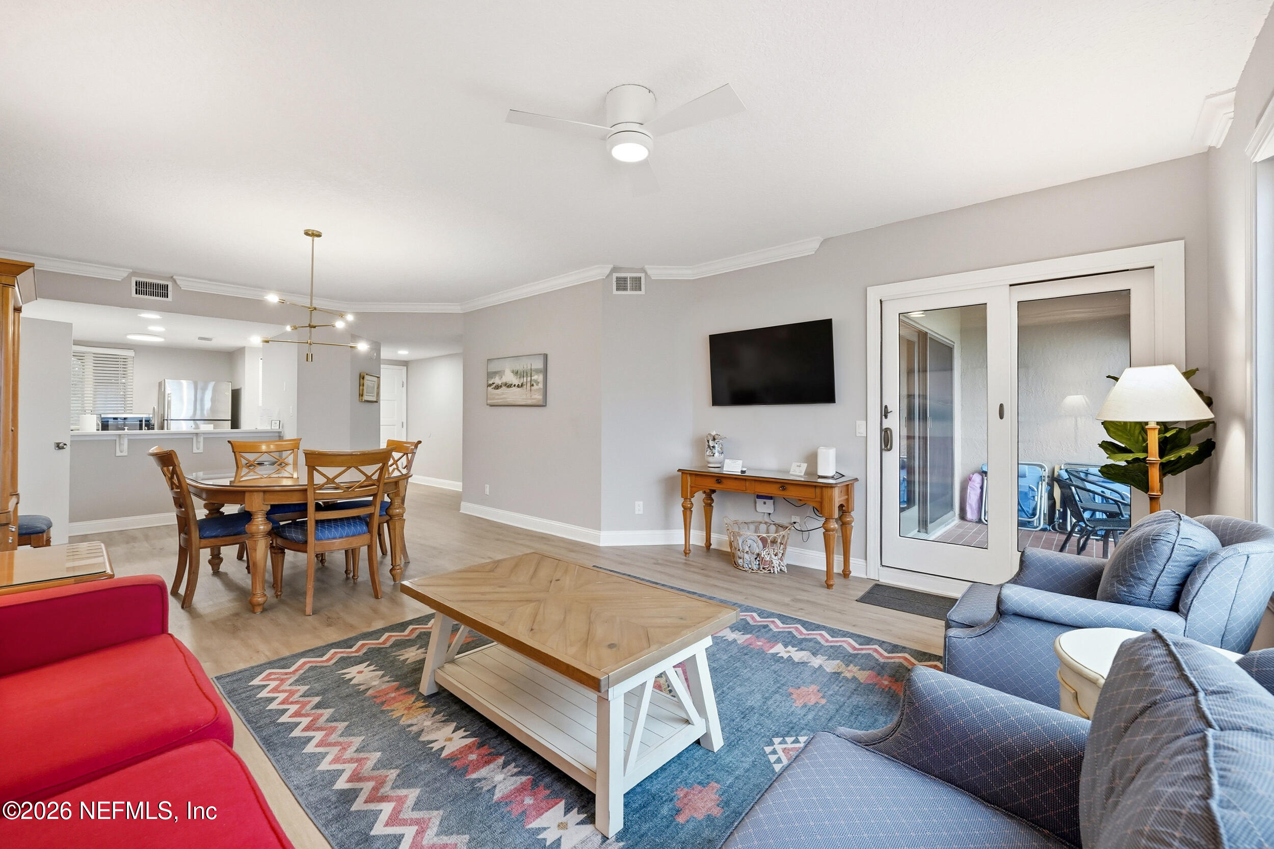 1817 Turtle Dunes Place Fernandina Beach, FL 32034 - Photo 5 of 34 a living room with furniture a dining table and a fireplace