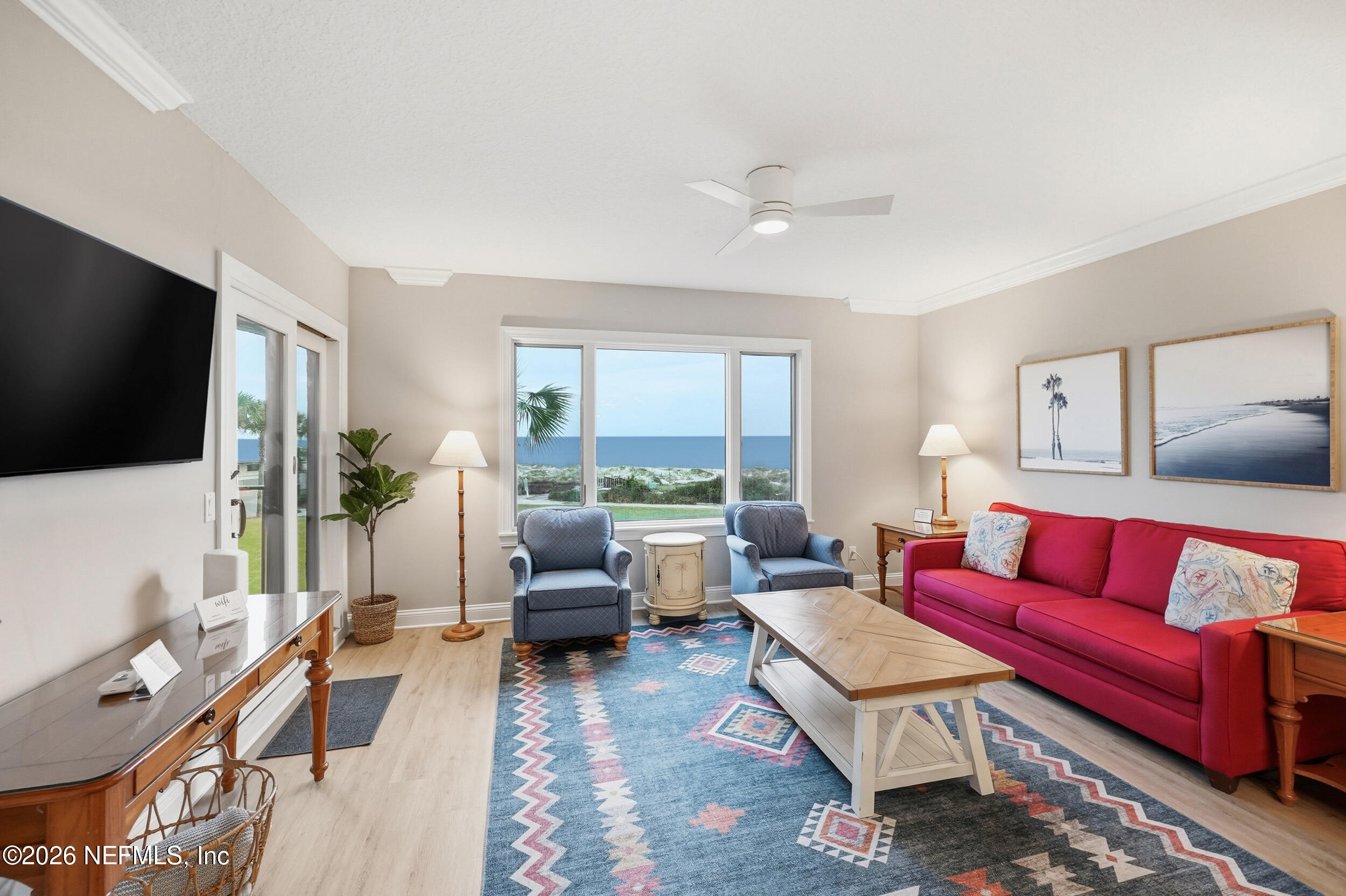 1817 Turtle Dunes Place Fernandina Beach, FL 32034 - Photo 7 of 34 a living room with furniture a flat screen tv and a large window
