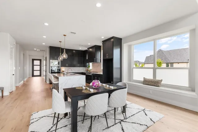 a kitchen with stainless steel appliances kitchen island granite countertop a refrigerator and microwave