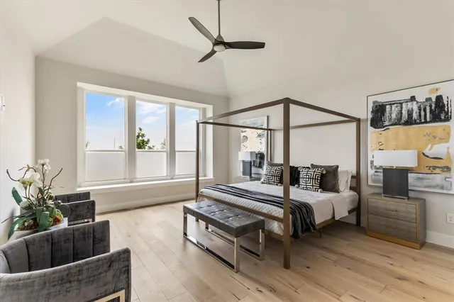 a bedroom with a bed a couch and potted plant with the outer view