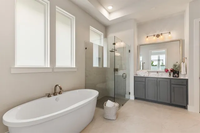 a white bath tub sitting next to a bathroom