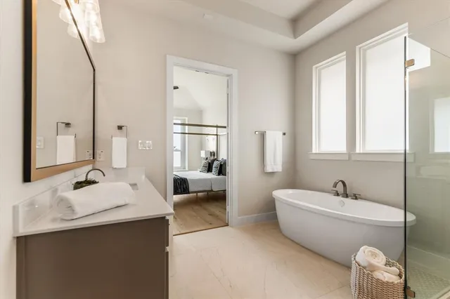 a bathroom with a tub sink and mirror