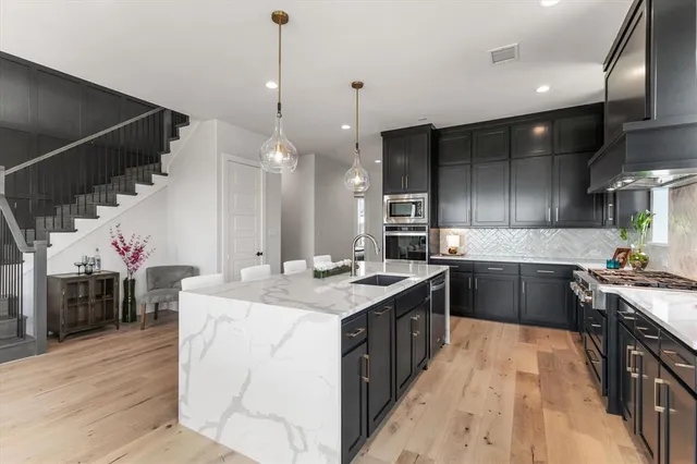 a large kitchen with a stove and a wooden floors