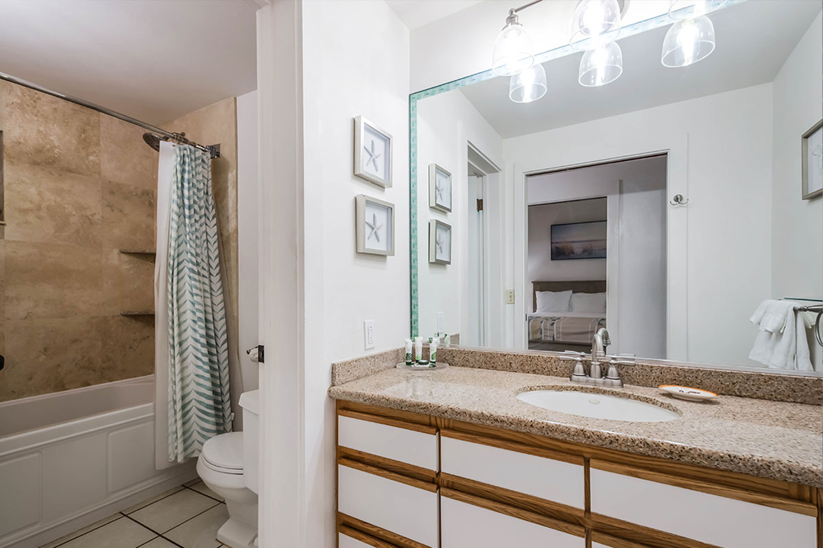 2253 Poipu Road, Unit 230 Koloa, HI 96756 - Photo 13 of 27 a bathroom with a granite countertop sink a toilet and bathtub