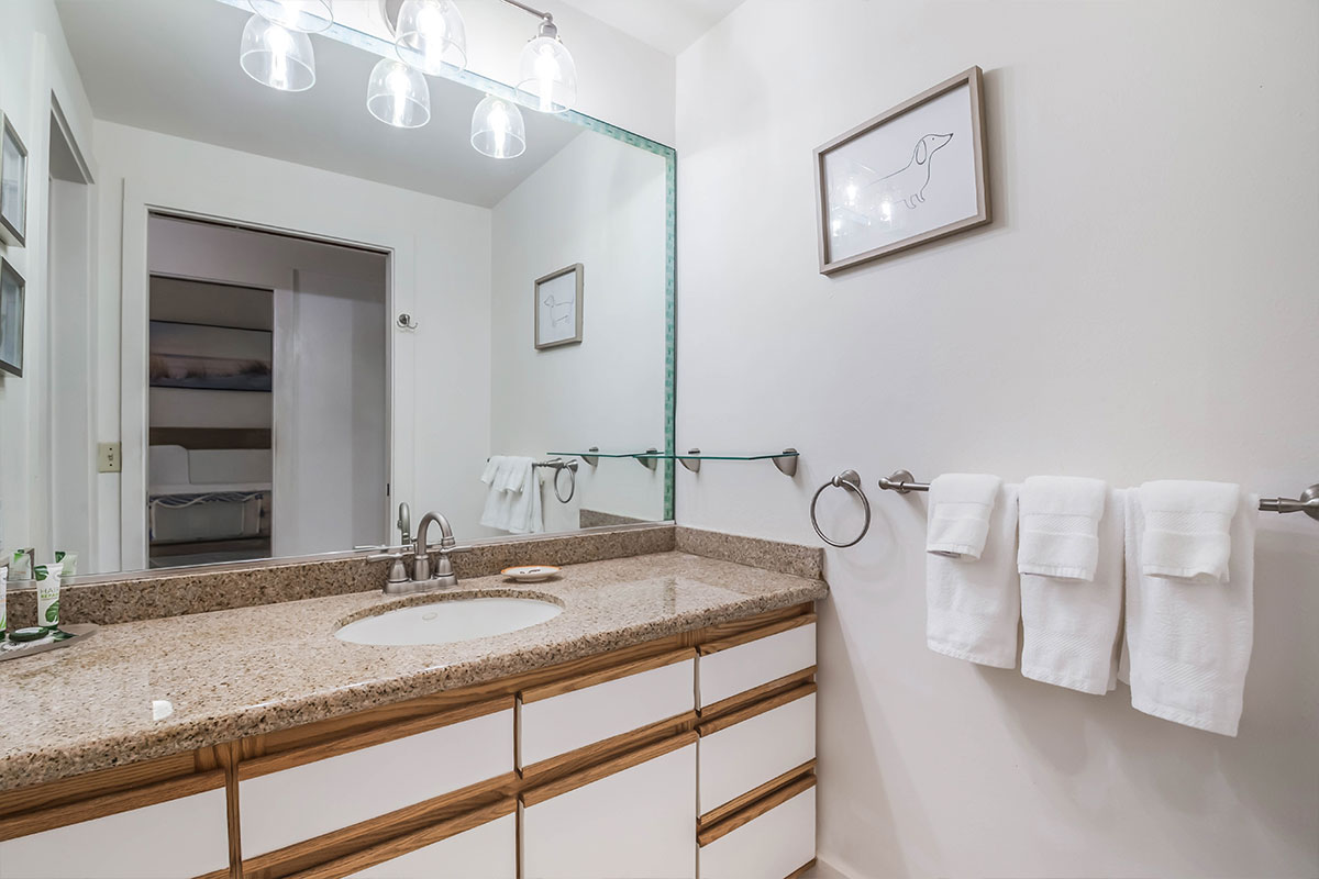 2253 Poipu Road, Unit 230 Koloa, HI 96756 - Photo 14 of 27 a bathroom with a granite countertop sink and a mirror
