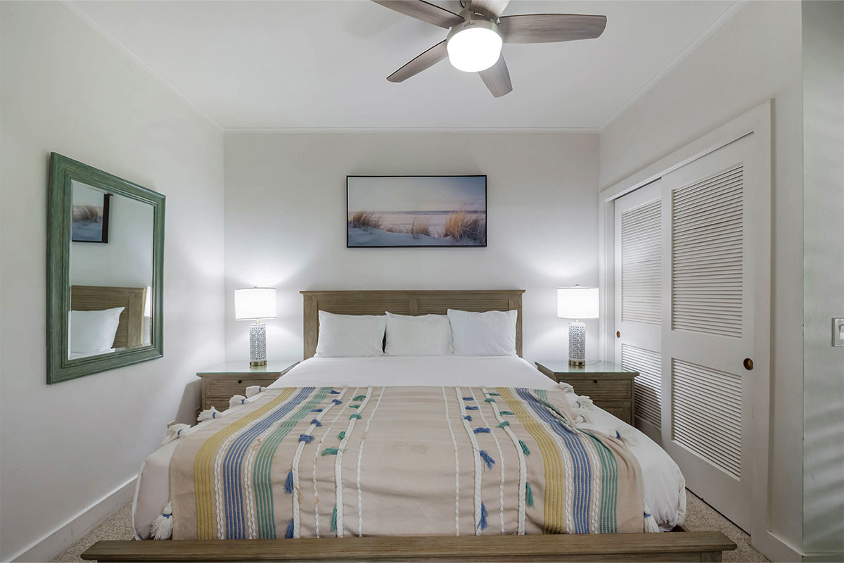 2253 Poipu Road, Unit 230 Koloa, HI 96756 - Photo 2 of 27 a bedroom with a bed and a painting on the wall