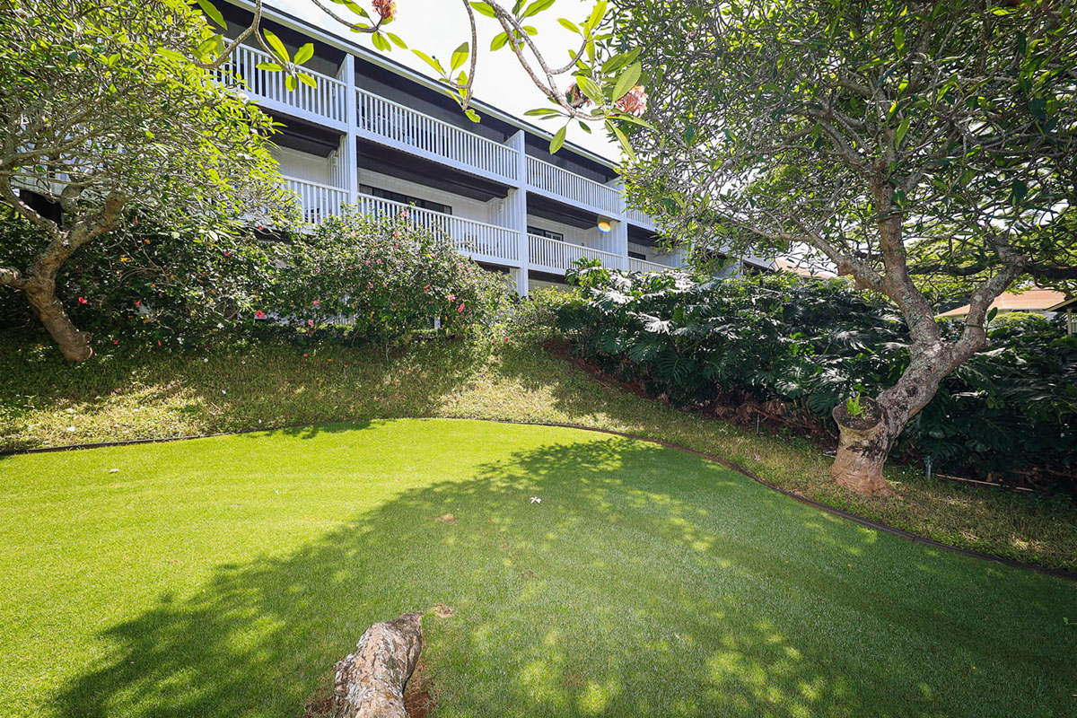 2253 Poipu Road, Unit 230 Koloa, HI 96756 - Photo 22 of 27 a view of a backyard with plants and large trees