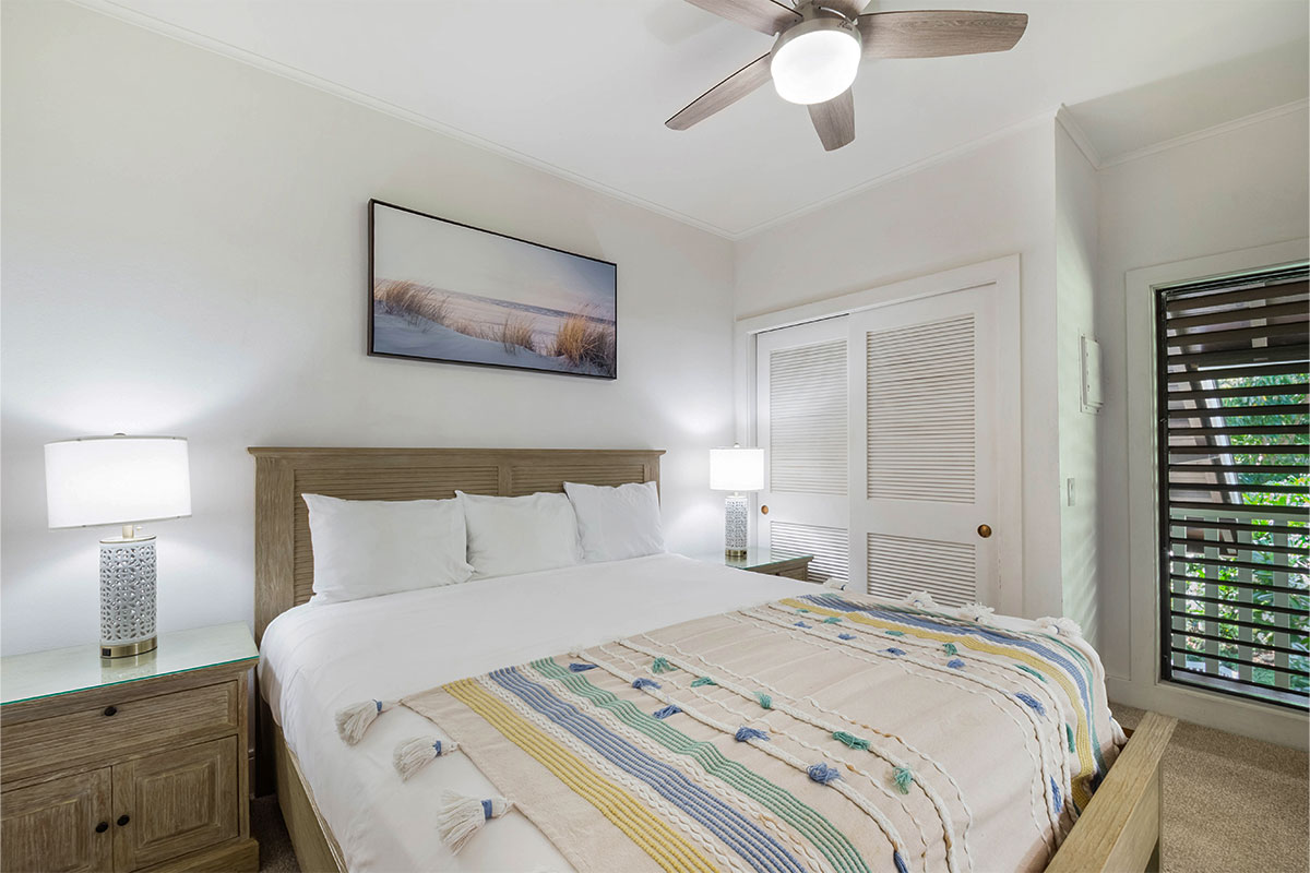 2253 Poipu Road, Unit 230 Koloa, HI 96756 - Photo 3 of 27 a bedroom with a bed and a chandelier