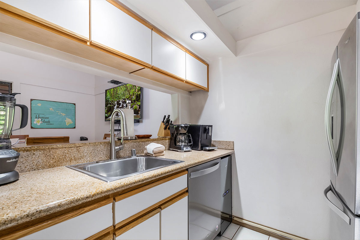 2253 Poipu Road, Unit 230 Koloa, HI 96756 - Photo 8 of 27 a kitchen with stainless steel appliances granite countertop a sink a stove and a refrigerator