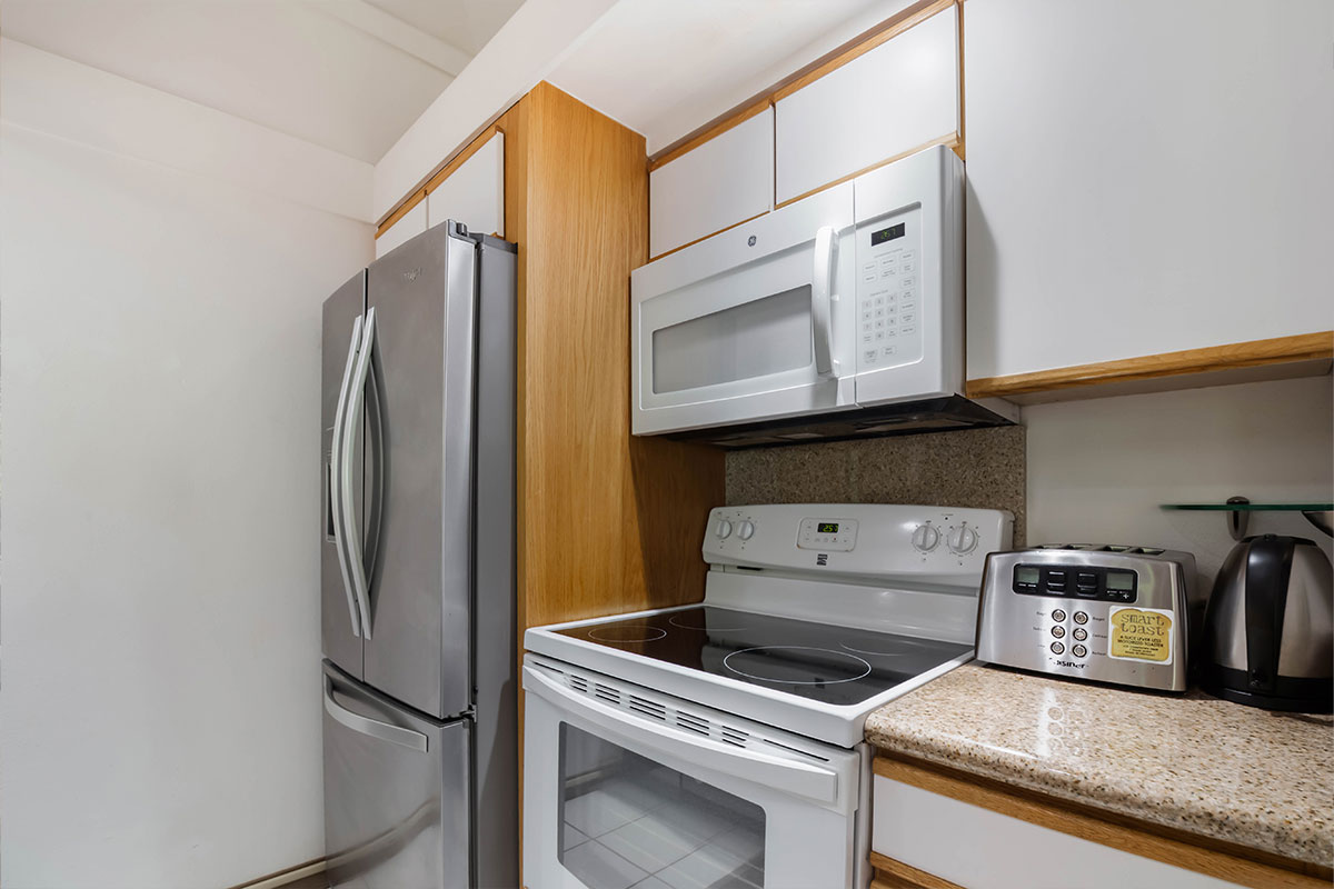2253 Poipu Road, Unit 230 Koloa, HI 96756 - Photo 9 of 27 a kitchen with stainless steel appliances granite countertop a refrigerator and a stove