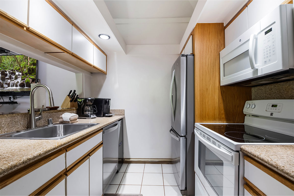 2253 Poipu Road, Unit 230 Koloa, HI 96756 - Photo 10 of 27 a kitchen with a sink stove and cabinets