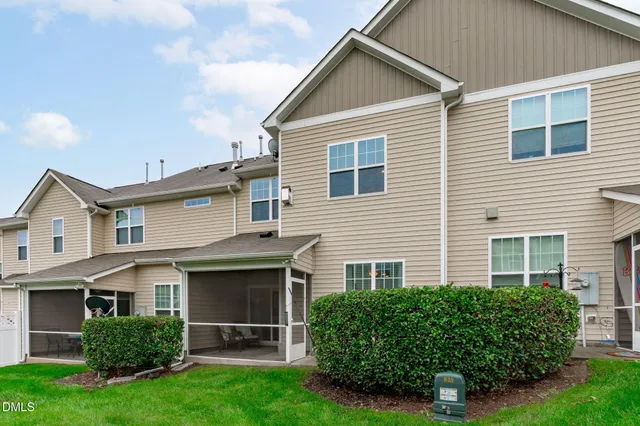 a front view of a house with a yard and green space