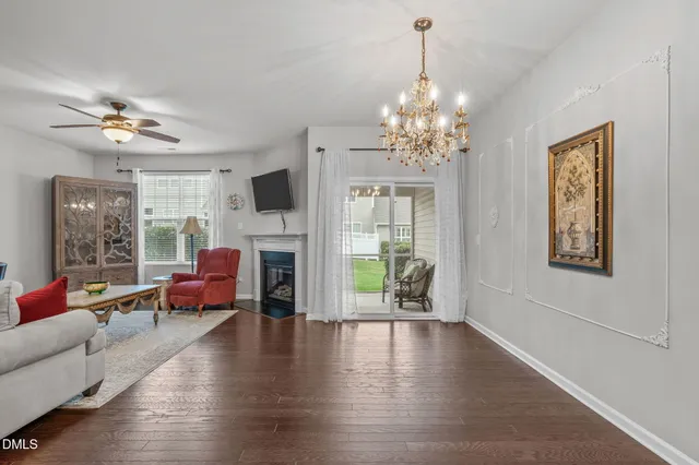 a living room with fireplace furniture and a wooden floor