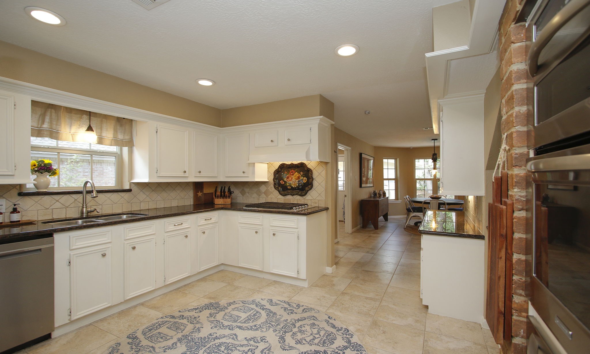 9546 Enstone Circle Spring, TX 77379 - Photo 13 of 44 a kitchen with a sink and cabinets