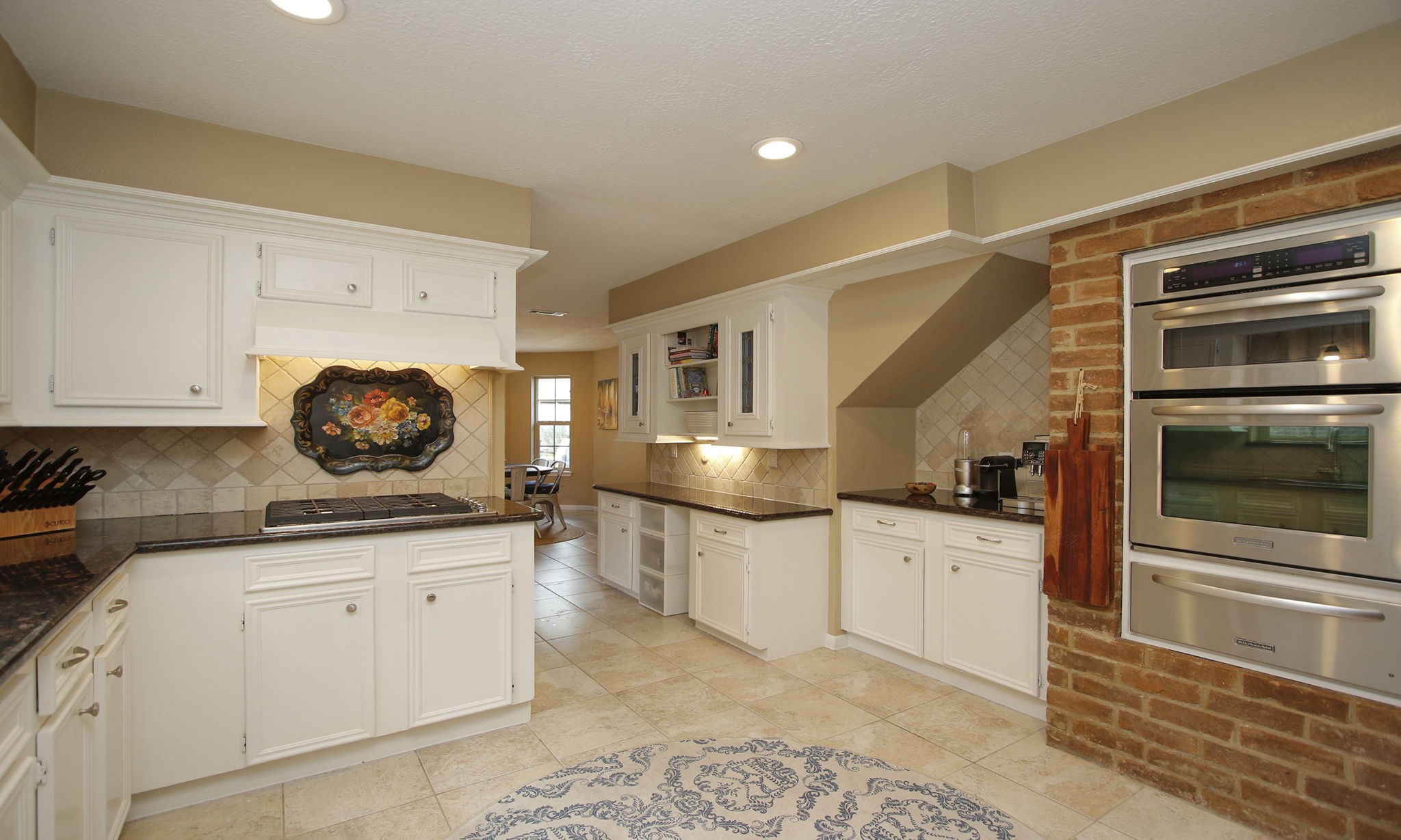 9546 Enstone Circle Spring, TX 77379 - Photo 14 of 44 Charming brick accent wall surrounds the oven, microwave and warming drawer.